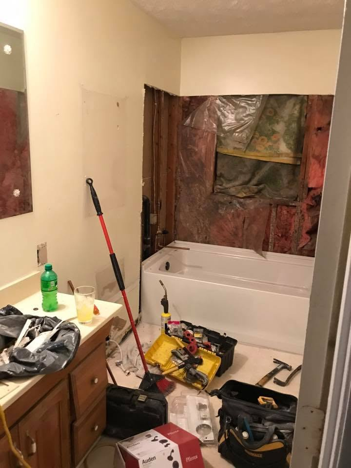 Bathroom torn down to the studs with tub surround removed