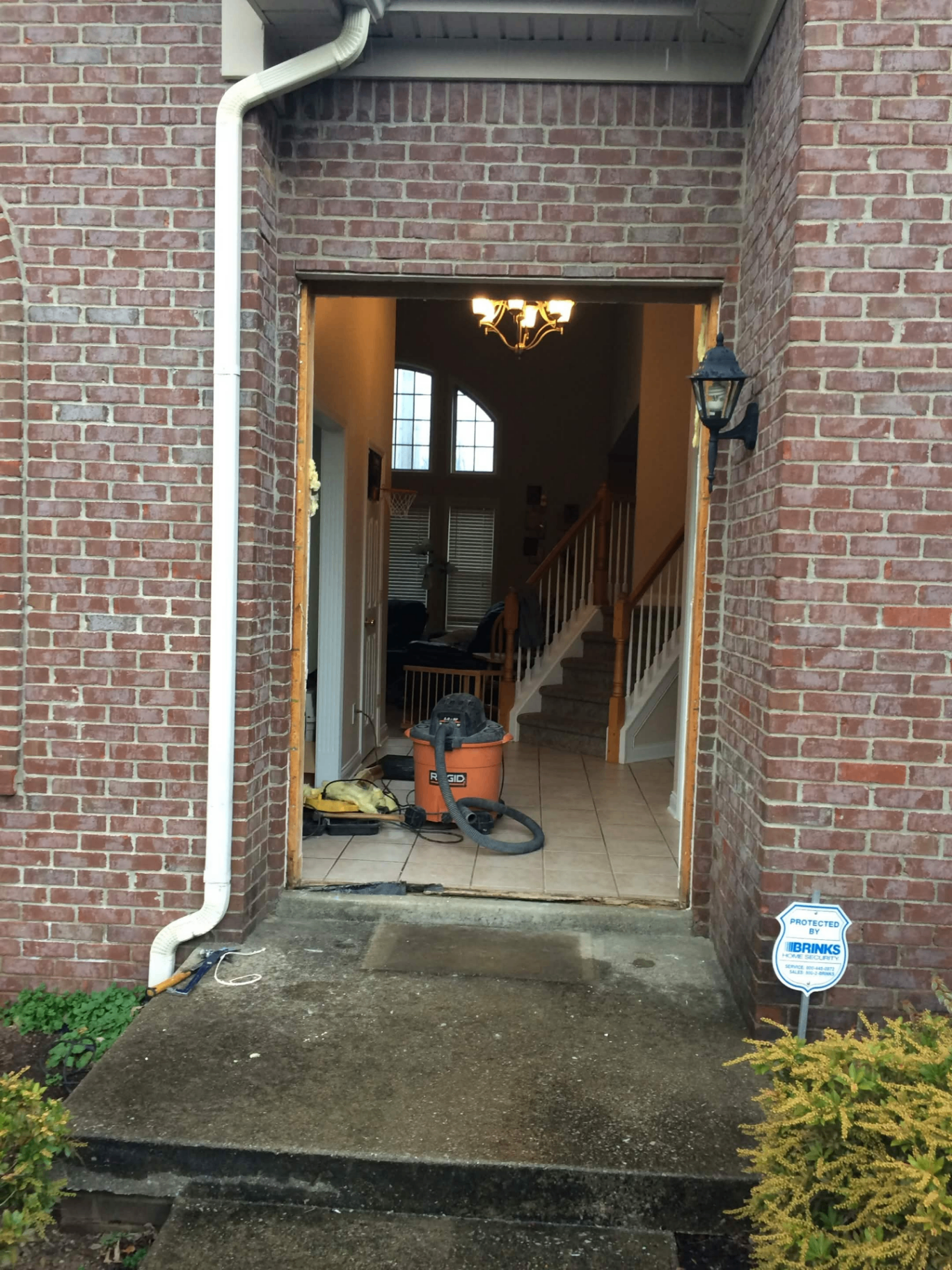 Front door removed, brick entryway prepped for new door installation
