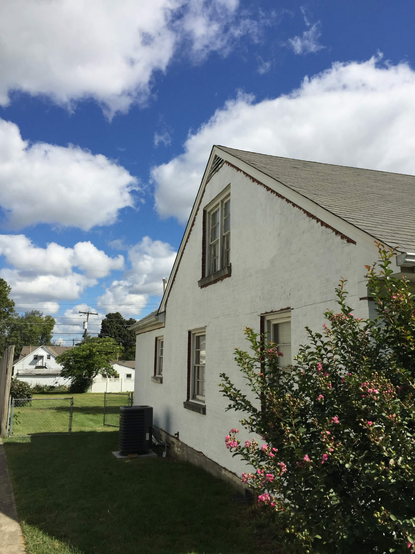 White painted brick house exterior before repaint