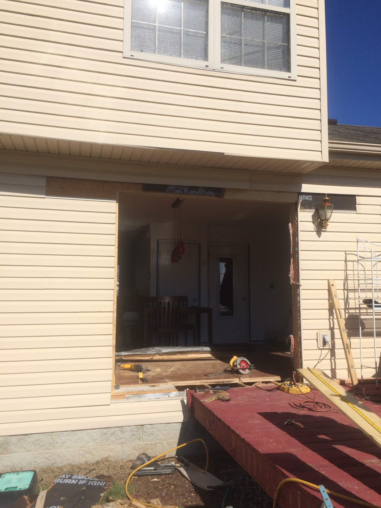 Rough opening cut into the side of a house for a new patio door
